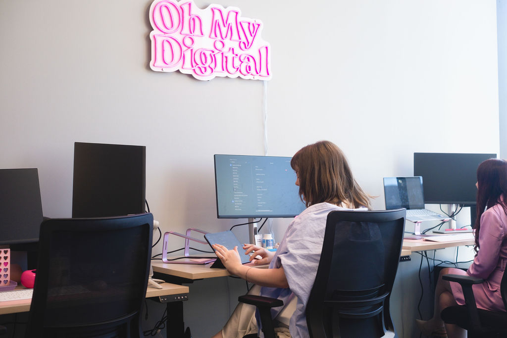 OMD team mapping client journey on laptops in Brisbane studio